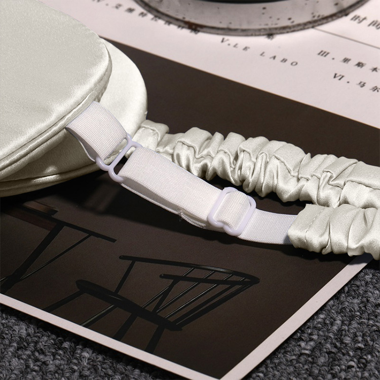 Adjustable elastic strap detail on silver silk eye mask