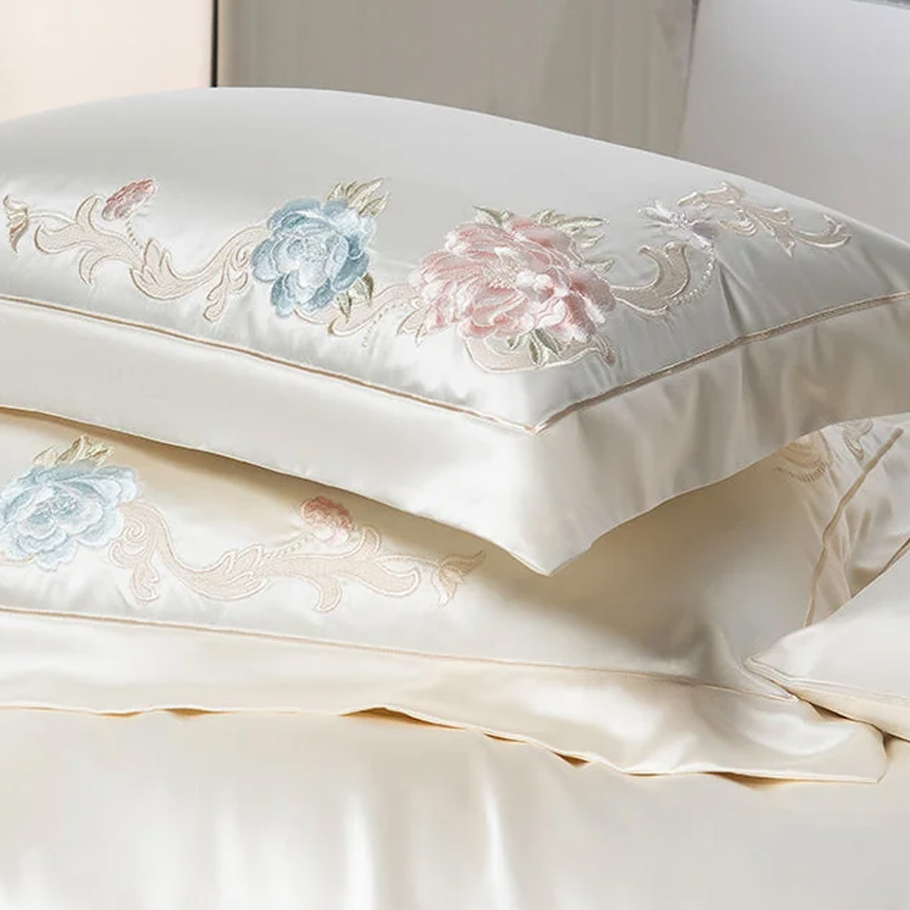 Detail shot of floral embroidered silk pillowcases