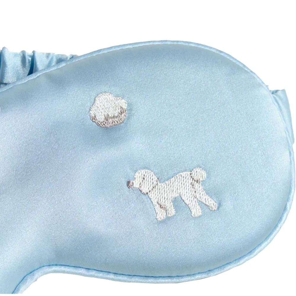 Dog and cloud embroidery detail on blue silk eye mask