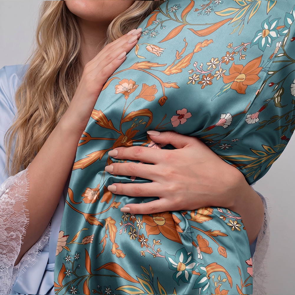 Model holding luxury vintage pattern printed mulberry silk pillowcase for sleep care