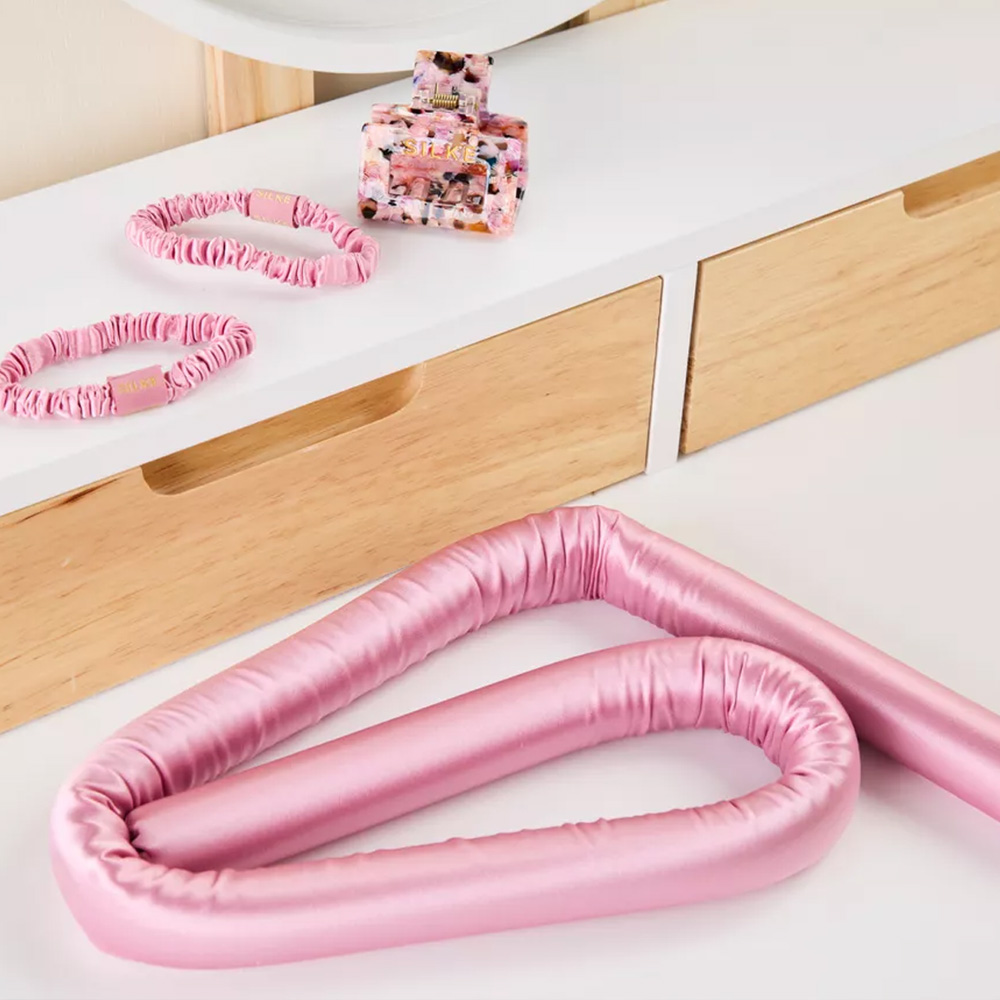 Pink silk heatless curling rod set on vanity desk