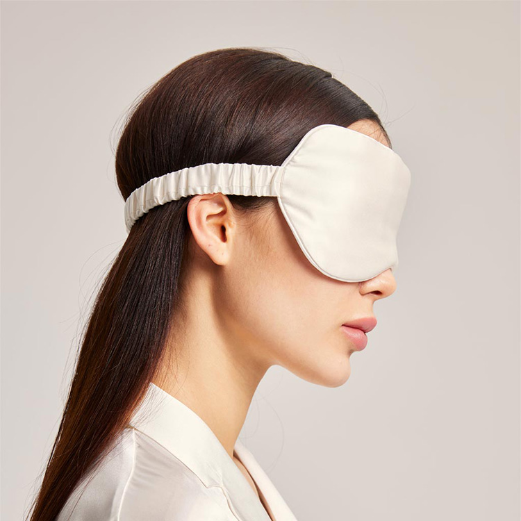Model wearing silver silk sleep mask side view