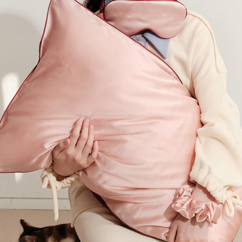 Model holding soft pink pure mulberry silk pillowcase
