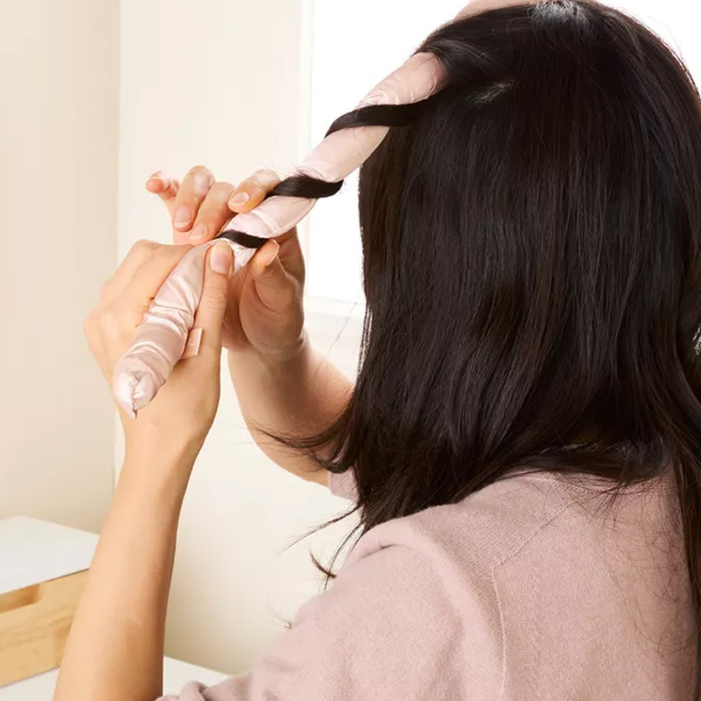 Demonstrating hair wrapping on silk heatless curler