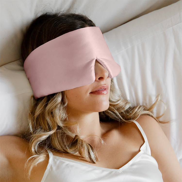 Woman wearing pink wrap around silk sleep mask