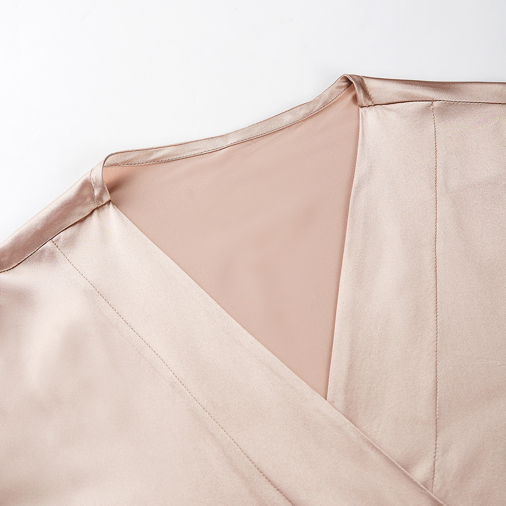 V-neckline detail of light pink silk bathrobe