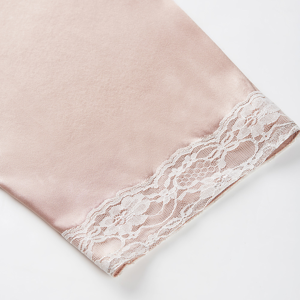 Lace trim detail on pink silk bathrobe sleeve