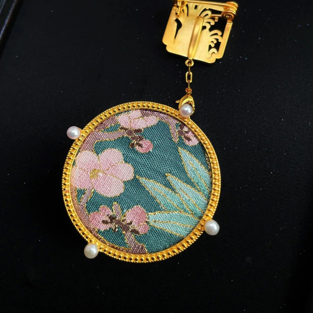 Close up of Chinese floral embroidered round pendant