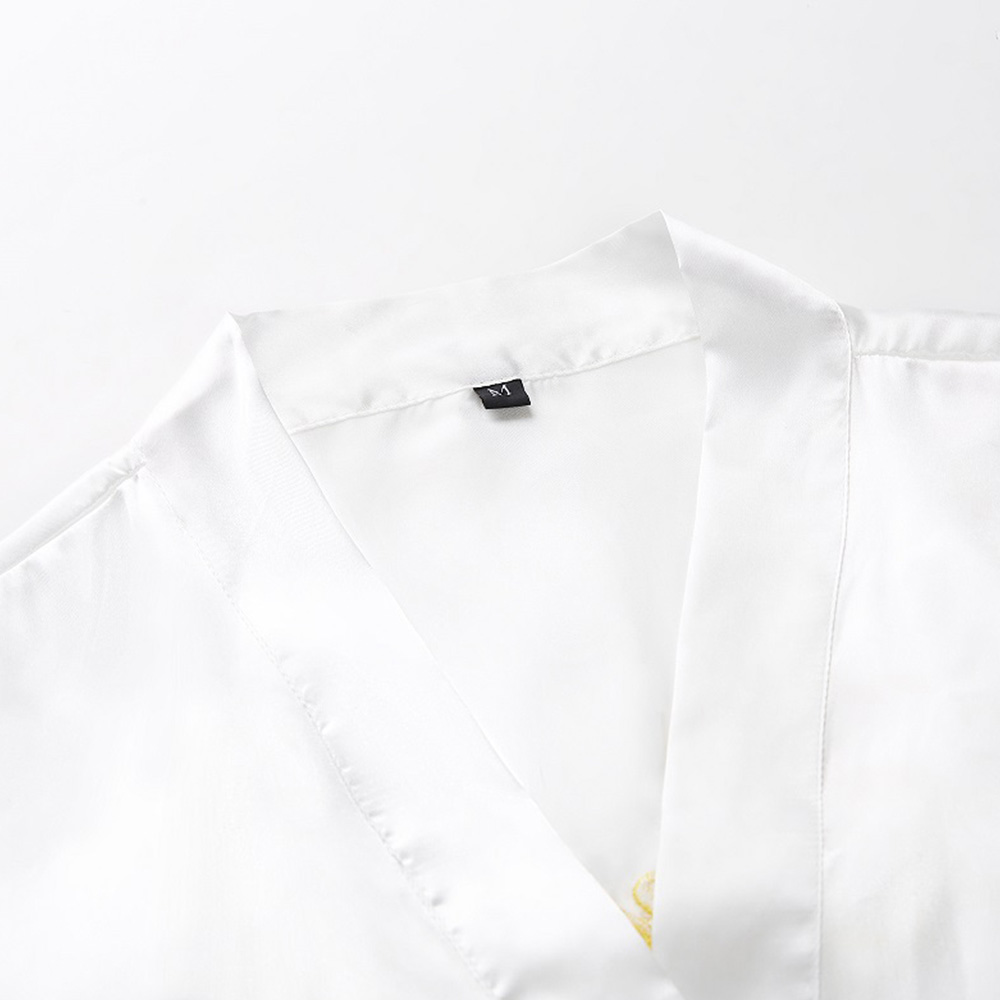 V-neckline detail of white silk bridal robe